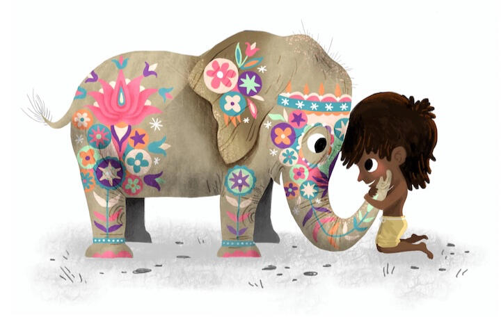 a boy and a baby elephant hug, the elephant is painted for a festival